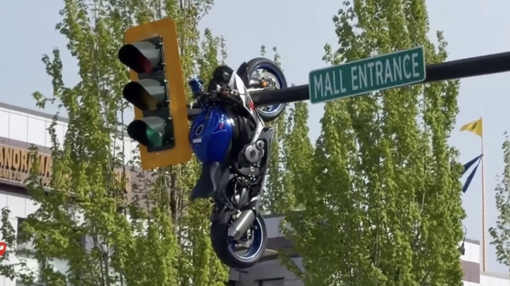 Motorcycle Hangs Out After Crash Launched It On To Street Sign